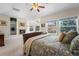 Comfortable bedroom with a fireplace and large windows providing plenty of natural light at 7425 S Utica St, Littleton, CO 80128
