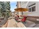 Outdoor patio features a dining table with umbrella and a heater for comfortable outdoor living at 7425 S Utica St, Littleton, CO 80128
