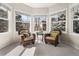 Bright sitting room with bay windows providing natural light and comfortable seating at 7425 S Utica St, Littleton, CO 80128