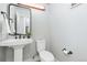 Modern powder room with pedestal sink and updated toilet at 3260 Curtis St, Denver, CO 80205