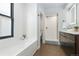 Stylish bathroom with soaking tub, walk-in shower, and dark vanity at 3260 Curtis St, Denver, CO 80205