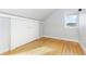 Small bedroom with wood floors and white built-ins at 3260 Curtis St, Denver, CO 80205