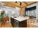 Open concept kitchen with island, stainless steel appliances, and exposed brick at 3260 Curtis St, Denver, CO 80205