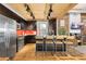 Modern kitchen with dark cabinetry, stainless steel appliances, and an island at 3260 Curtis St, Denver, CO 80205