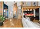 Open living space with exposed brick, hardwood floors, and loft at 3260 Curtis St, Denver, CO 80205