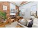 Cozy living room with exposed brick fireplace and hardwood floors at 3260 Curtis St, Denver, CO 80205