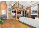 Open concept living area with hardwood floors and exposed brick at 3260 Curtis St, Denver, CO 80205