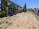 A wide view of the backyard showing a brick foundation, deck and fence at 327 S Pine St, Elizabeth, CO 80107