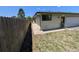 Exterior side view of a house showing the fence, sidewalk and garage at 327 S Pine St, Elizabeth, CO 80107