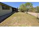 Inviting front yard with lush green grass, mature trees, and a charming home exterior at 327 S Pine St, Elizabeth, CO 80107