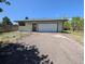 This property includes a detached garage with a large white door at 327 S Pine St, Elizabeth, CO 80107