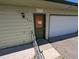 House exterior with garage door, sidewalk, and side door at 327 S Pine St, Elizabeth, CO 80107