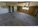 Spacious garage featuring built-in shelving, natural light from window, and convenient garage door at 327 S Pine St, Elizabeth, CO 80107
