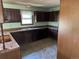Traditional kitchen needing renovation features dark cabinetry and a window offering natural light at 327 S Pine St, Elizabeth, CO 80107