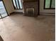 Living room featuring a brick fireplace, windows, and sliding glass doors at 327 S Pine St, Elizabeth, CO 80107
