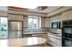 A kitchen with white countertops and cabinets with stainless steel appliances at 5449 S Locust St, Greenwood Village, CO 80111