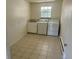 Laundry room featuring tile flooring, washer, dryer, and utility sink at 5449 S Locust St, Greenwood Village, CO 80111