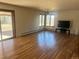 Bright, airy living room with hardwood floors, large windows and sliding glass door at 5449 S Locust St, Greenwood Village, CO 80111