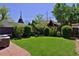 Backyard oasis featuring lush greenery, a well-kept lawn, and a charming patio area at 747 N Downing St, Denver, CO 80218