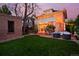 Charming backyard featuring a manicured lawn, patio seating, and an inviting sunroom at 747 N Downing St, Denver, CO 80218