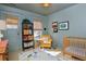 Charming bedroom with a warm color scheme, featuring a crib and wicker baskets for added storage at 747 N Downing St, Denver, CO 80218