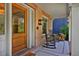 Close-up of the home's front porch with rocking chairs and wood storage, emphasizing the welcoming entrance and charming details at 747 N Downing St, Denver, CO 80218