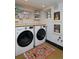 Bright laundry room with modern washer and dryer, floating shelves, and decorative rug at 747 N Downing St, Denver, CO 80218