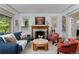 Comfortable living room showcasing a fireplace, elegant decor, and a view of the dining area, creating a warm atmosphere at 747 N Downing St, Denver, CO 80218