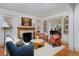 Open-concept living room with built-in bookshelves and a view of the dining area at 747 N Downing St, Denver, CO 80218