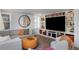 Stylish living room featuring a comfortable sectional sofa, built-in bookshelves, and a large screen TV at 747 N Downing St, Denver, CO 80218