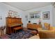 Cozy living room featuring a vintage piano, mid-century modern furniture, and unique art, creating a welcoming and stylish space at 747 N Downing St, Denver, CO 80218