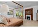 Serene bedroom with a four-poster bed, fireplace, bright windows, and neutral carpet at 747 N Downing St, Denver, CO 80218