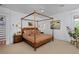 Bedroom with four-poster bed, side tables, and decoratively framed porthole window at 747 N Downing St, Denver, CO 80218
