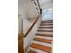 Staircase with stained wood treads and white risers, lit by a stained-glass window at 747 N Downing St, Denver, CO 80218