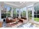 Bright sun room featuring marble tile floors, many windows and comfortable seating area with a sofa at 747 N Downing St, Denver, CO 80218