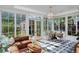 Bright sun room featuring marble tile floors, many windows and comfortable seating area at 747 N Downing St, Denver, CO 80218
