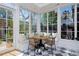 Bright sun room with marble floors, many windows, and a seating nook with a table and chairs at 747 N Downing St, Denver, CO 80218