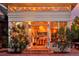 Exterior night shot of the sunroom entrance, framed by brick steps and lush landscaping at 747 N Downing St, Denver, CO 80218