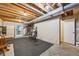 Unfinished basement with an exercise bike, refrigerator, and concrete floors at 7474 E Arkansas Ave # 13-02, Denver, CO 80231