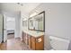 This bathroom features a double sink vanity and a door to a bedroom at 7474 E Arkansas Ave # 13-02, Denver, CO 80231