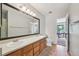 This bathroom features a double sink vanity and a door to a bedroom at 7474 E Arkansas Ave # 13-02, Denver, CO 80231