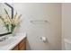 Clean, simple half-bath featuring a sink, toilet, and flower decoration at 7474 E Arkansas Ave # 13-02, Denver, CO 80231