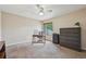This bedroom features a ceiling fan, large window, desk, dresser, and neutral colored walls at 7474 E Arkansas Ave # 13-02, Denver, CO 80231