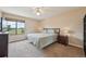 Bright bedroom featuring a comfortable bed, ceiling fan, and a large window with a view at 7474 E Arkansas Ave # 13-02, Denver, CO 80231