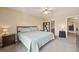 Inviting bedroom with neutral tones, soft carpet, and a comfortable bed setup with lamps at 7474 E Arkansas Ave # 13-02, Denver, CO 80231