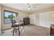 This bedroom features a large window, neutral carpet, and a ceiling fan at 7474 E Arkansas Ave # 13-02, Denver, CO 80231