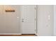 Clean entryway with a white door, wooden coat hooks, and neutral walls at 7474 E Arkansas Ave # 13-02, Denver, CO 80231
