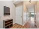 Hallway with wood flooring, a storage bench, and multiple doorways leading to rooms at 7474 E Arkansas Ave # 13-02, Denver, CO 80231