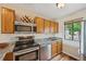 Updated kitchen featuring granite countertops, stainless steel appliances, and wood cabinetry at 7474 E Arkansas Ave # 13-02, Denver, CO 80231