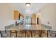 This kitchen features a breakfast bar with seating, stainless steel appliances, and granite countertops at 7474 E Arkansas Ave # 13-02, Denver, CO 80231